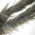Close-up view of Renzetti Lively Legs Streamer Brush in peacock and olive colors, displaying textured fibers with iridescent highlights used for fly fishing lures.