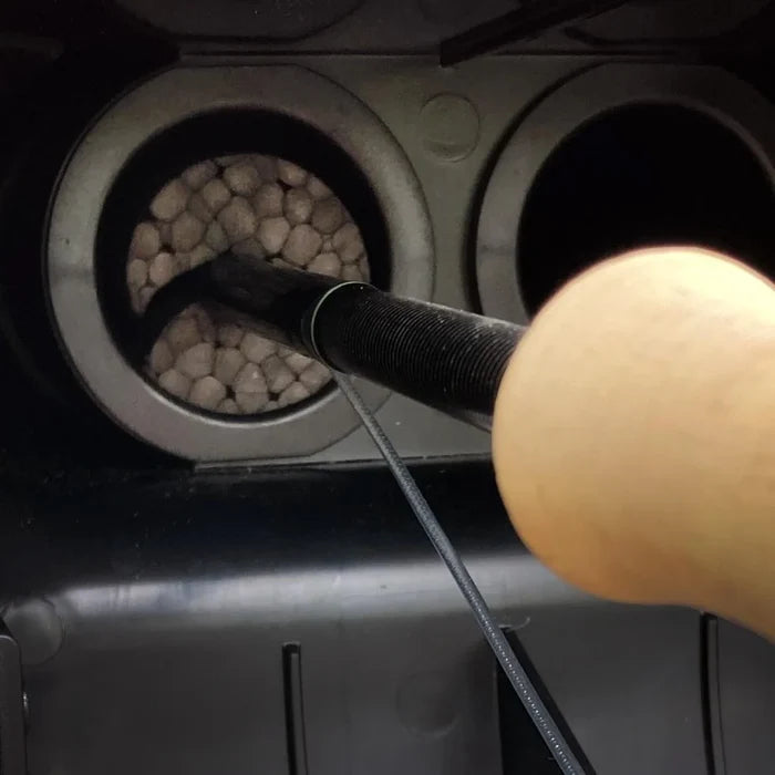 Close-up image of a fishing rod with a wood handle secured in a rooftop fly rod carrier, showcasing the Riversmith River Quiver Rod Chairs designed for organized fishing tackle storage.