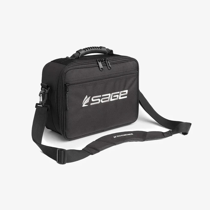 Compact black carrying case with padded shoulder strap and sturdy handle, featuring the Sage logo, designed for organized storage of fishing reels labeled Sage Ballistic Reel Brief.