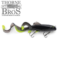 Savage Gear 3D Sucker X-Tail fishing lure in black and chartreuse with two treble hooks and a flexible curled tail designed to mimic natural fish movement for effective fishing tackle.