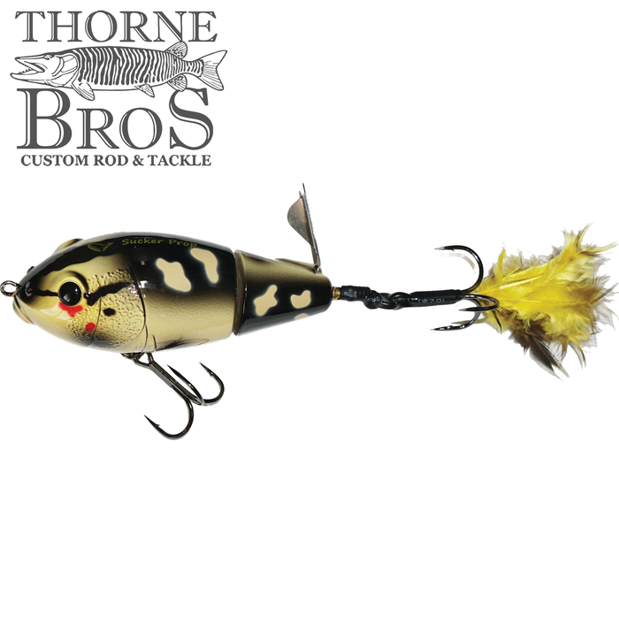 Savage Gear Sucker Prop fishing lure with lifelike fish pattern, jointed body, metal propeller, and feathered treble hook for attracting musky and other game fish.