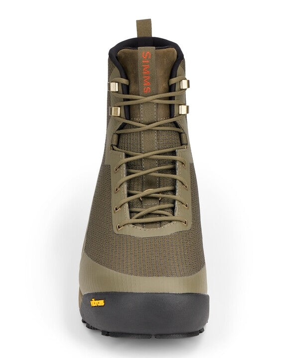 Simms Access Wading Boot in olive green with durable textured fabric upper, reinforced black rubber sole, secure lacing system, and orange logo on the tongue designed for fishing tackle enthusiasts.
