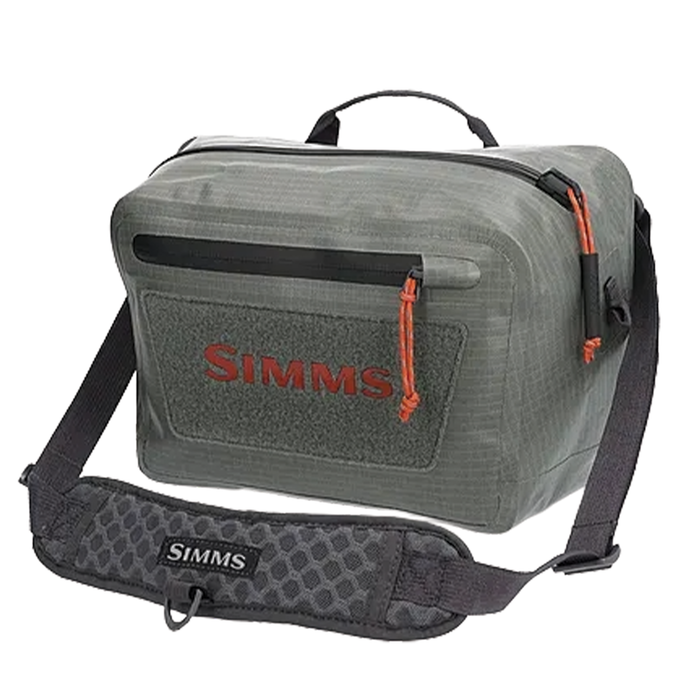 Simms Dry Creek Z Hip Pack in olive green with durable water-resistant fabric, front zippered pocket, and adjustable padded strap designed for carrying fishing tackle and gear.