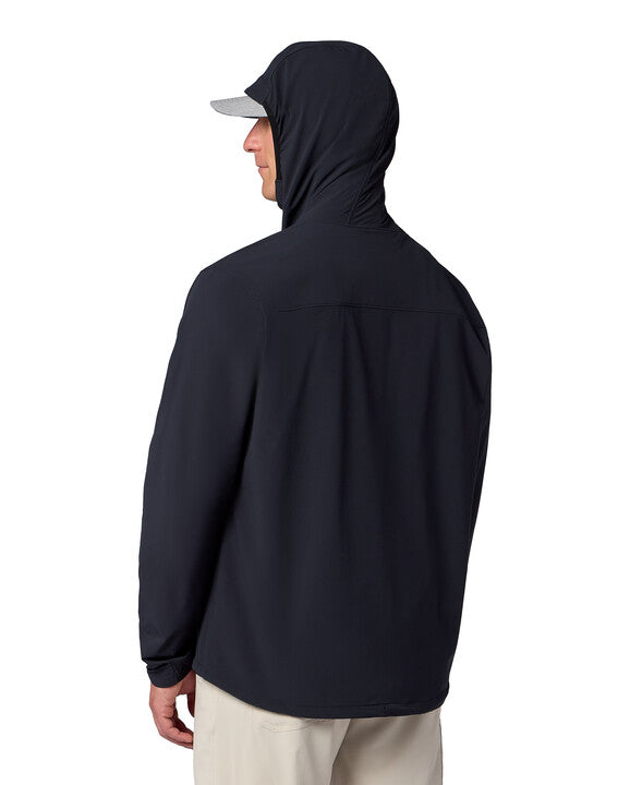 Man wearing a black Simms Rogue Flex Half-Zip Pullover with a hood, viewed from the back, paired with light-colored pants and a gray cap.
