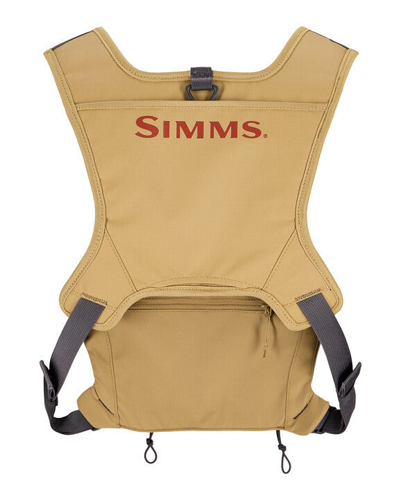 Simms Tributary Chest Pack in tan color, featuring adjustable black straps and multiple compartments for convenient storage of fishing tackle and gear.