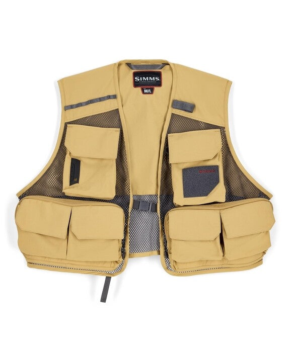 Simms Tributary Vest in tan color with multiple front pockets and mesh side panels designed for fishing tackle organization and comfortable wear during outdoor activities.
