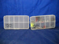 Two clear plastic compartmentalized Soth Fork Clear Poly Fly Box containers, one open holding various small fishing tackle items, against a blue background.
