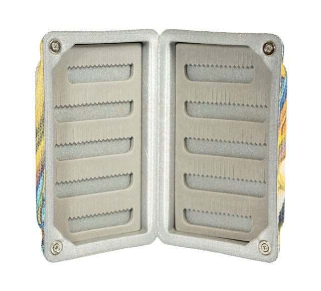 Open South Fork Traction Fly Box displaying multiple foam slots designed to securely hold fishing lures and flies, featuring a durable outer fabric shell with colorful pattern.