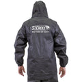 Back view of a person wearing a black waterproof St. Croix Men's Pro Lite Suit by Frogg Toggs with a hood and elastic cuffs, featuring a white logo on the upper back.