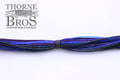 Starflash Musky Skirt 7'' Strand in a blue and black color mix with speckled glitter, designed for fishing tackle use with musky rods and reels.