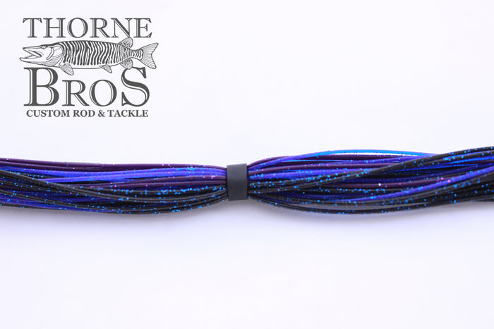 Starflash Musky Skirt 7'' Strand in a blue and black color mix with speckled glitter, designed for fishing tackle use with musky rods and reels.