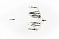 Stealth Rig 8 Blade fishing lure featuring eight reflective blades arranged on a white plastic frame with swivels and clips for musky fishing tackle.