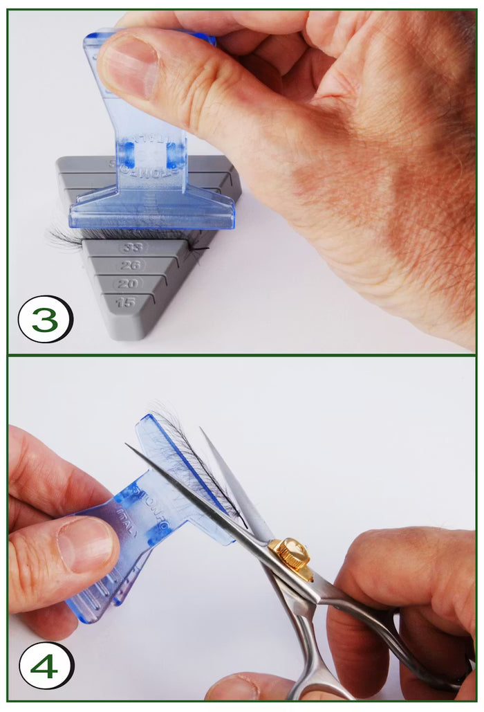 Hand holding a blue plastic Stonfo CDC Feathers Block with natural feathers clamped inside, and another hand using scissors to trim the feathers for fly fishing tackle preparation.