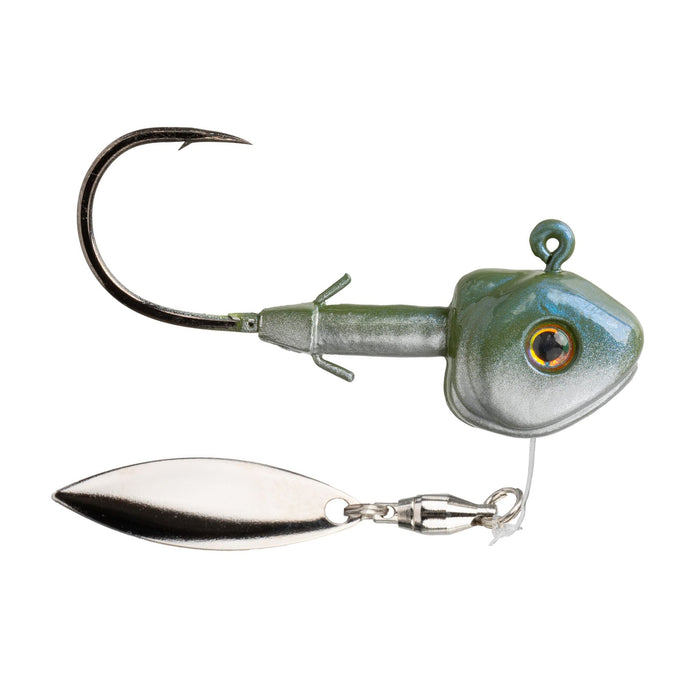 Close-up of a Strike King Tour Grade Fluorospin Underspin fishing lure featuring a sharp black hook, green and silver weighted head with a realistic eye, and a reflective silver spinner blade for attracting fish.
