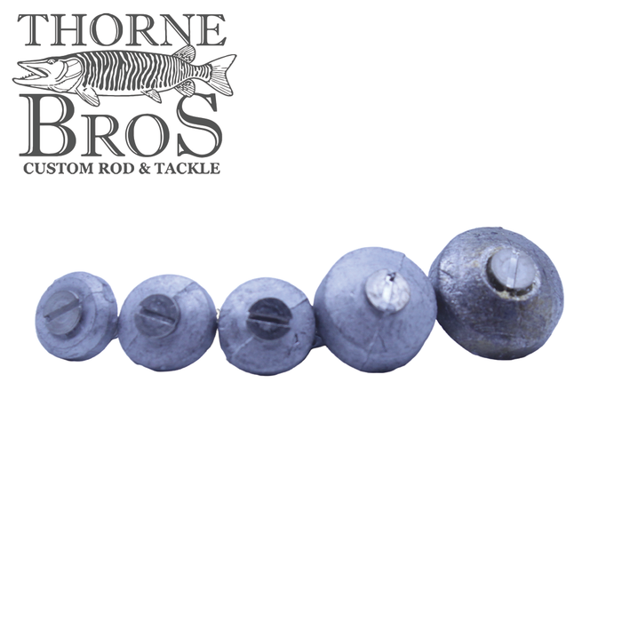 Five round, metallic weights of varying sizes arranged in a row on a white background, designed for fishing use as part of the Suick Weight Kit, with the Thorne Bros logo visible.