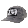 Thorne Bros. Logo Back Nine Hats in gray camouflage pattern with a curved brim and a black and white embroidered patch featuring a fish and the text "Thorne Bros Custom Rod & Tackle.
