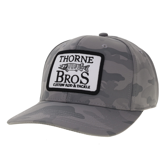 Thorne Bros. Logo Back Nine Hats in gray camouflage pattern with a curved brim and a black and white embroidered patch featuring a fish and the text "Thorne Bros Custom Rod & Tackle.