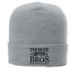 Thorne Bros Logo Cuff Beanie in light gray knit fabric featuring a black embroidered logo with a fish design, ideal for outdoor fishing enthusiasts.