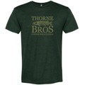 Thorne Bros. Logo T-Shirt in dark green with a printed design featuring a fish illustration and the text "THORNE BROS CUSTOM ROD & TACKLE" on the front.