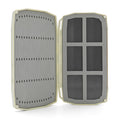 Umpqua Tailwater Foam Fly Box open to show dual foam panels with slotted slots on the left and grid compartments on the right for organizing fishing flies and tackle.