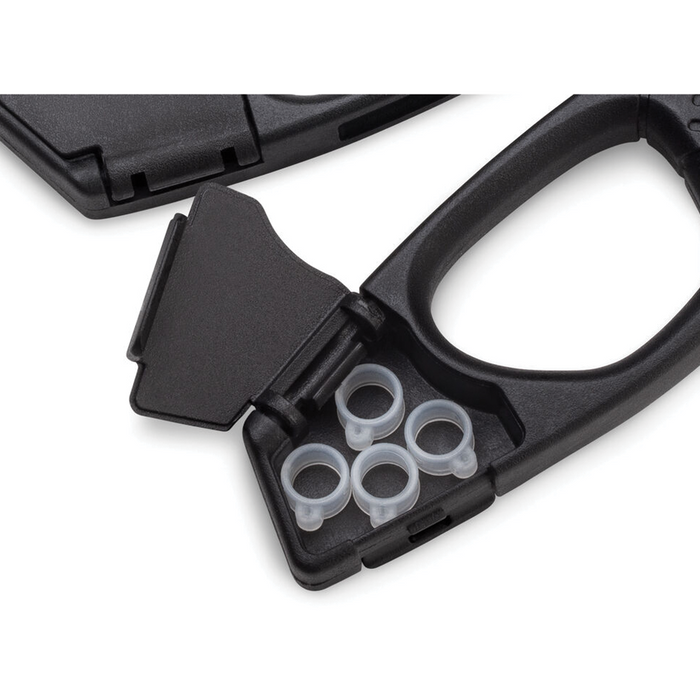 Close-up image of the black handle of VMC Crossover Pliers featuring a small compartment with a hinged lid containing four clear silicone ring keepers for fishing tackle organization.